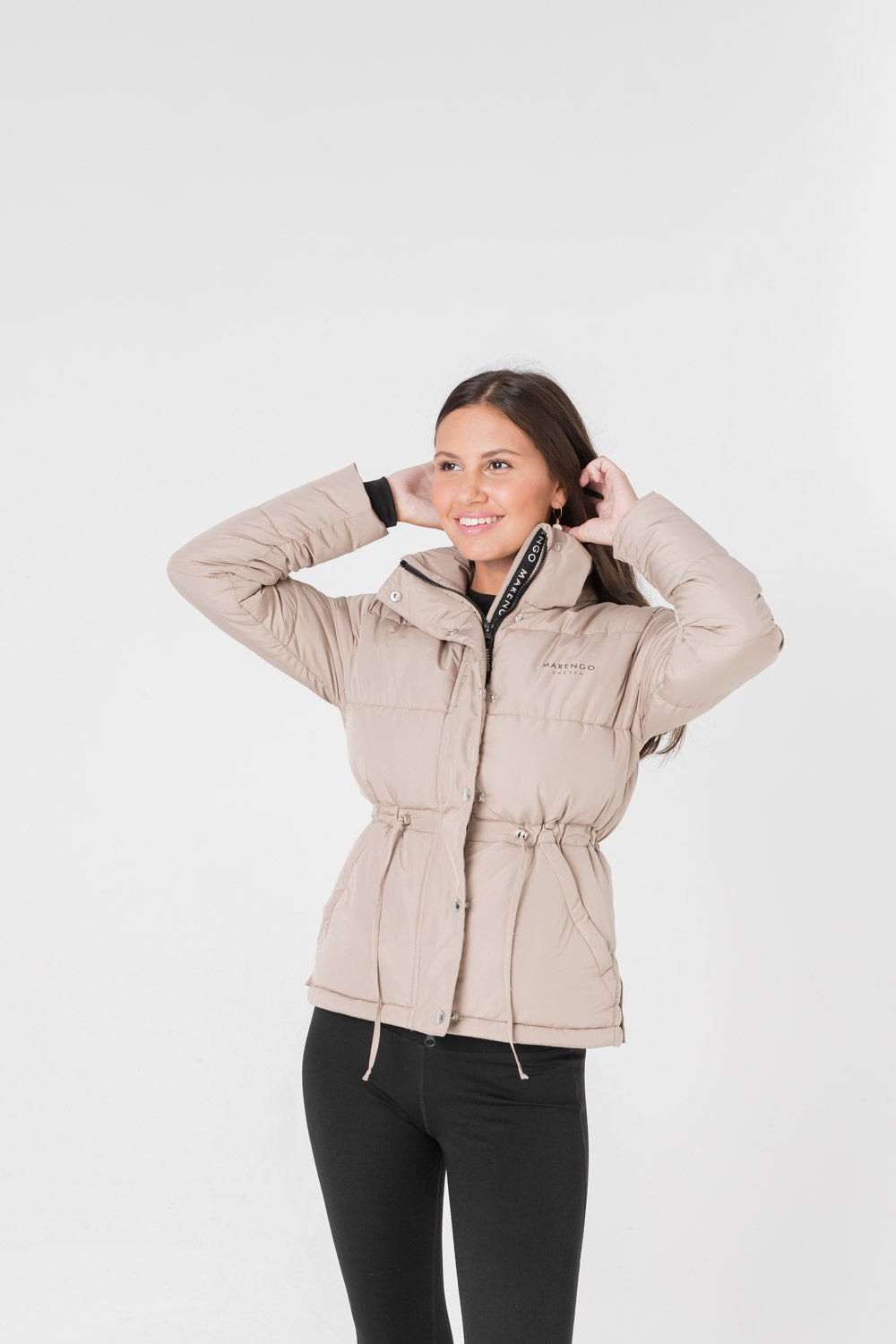 Beige padded jacket pose